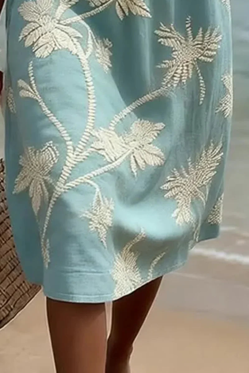 Volledige lengte shot van midi jurk met geborduurde bloemen, relaxed fit en V-hals