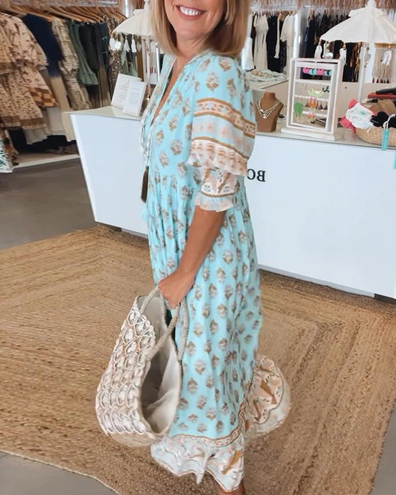 Achterkant van midi-jurk met vloeiend silhouet en print