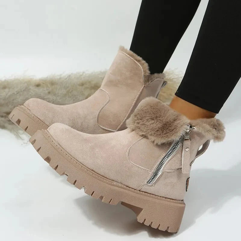 Zijaanzicht van dames winterlaarzen met decoratieve rits en robuuste zool voor grip op gladde ondergronden